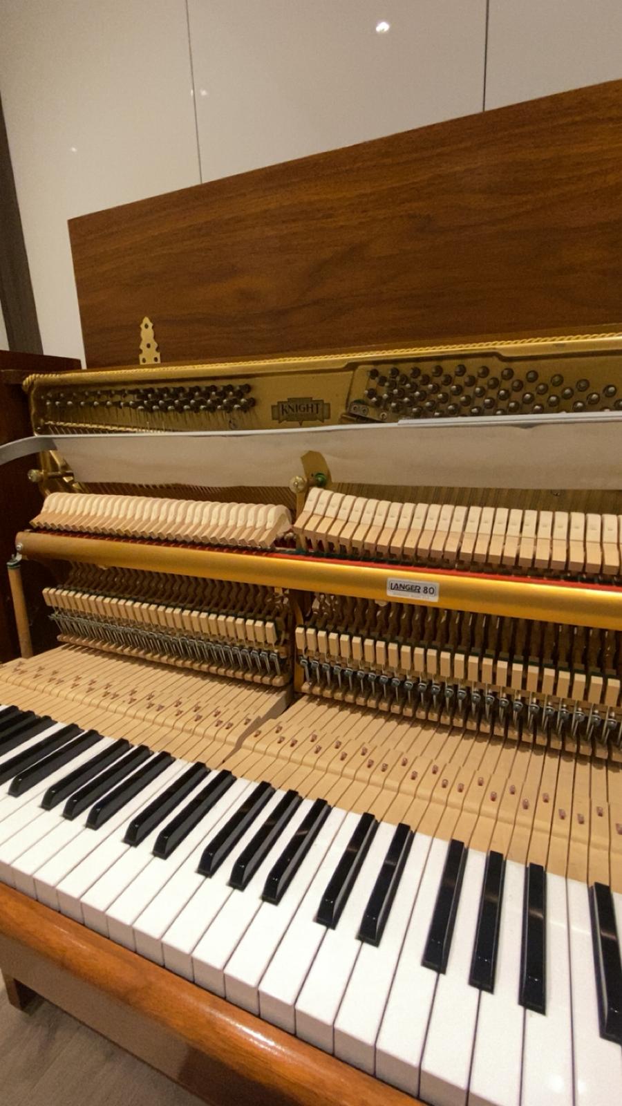 Close-up of an upright piano action: hammers and dampers